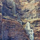 Dike emerging from a cliff